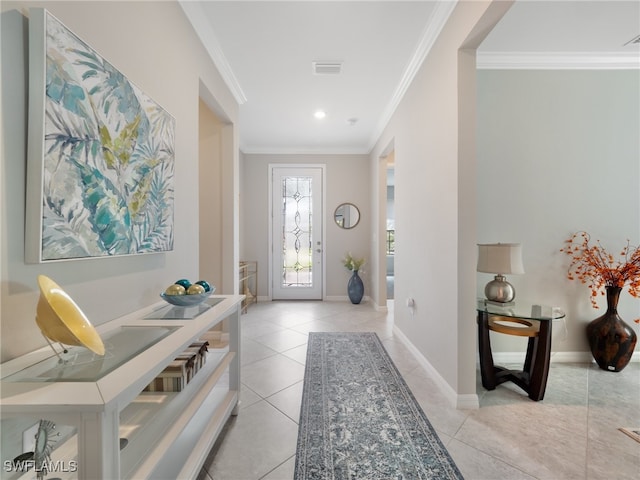 entryway with light tile patterned flooring and ornamental molding