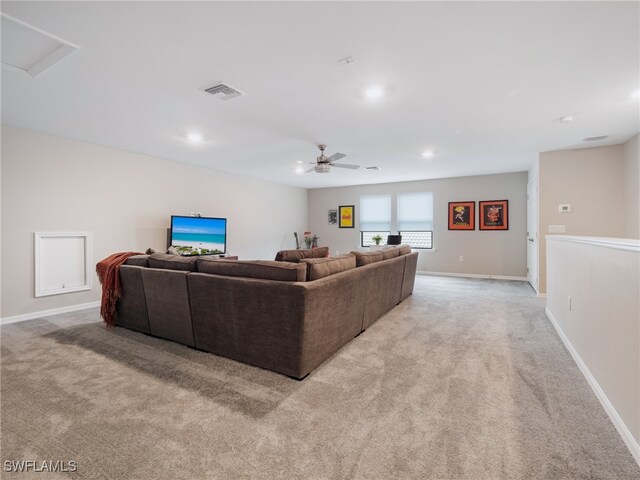 carpeted living room featuring ceiling fan