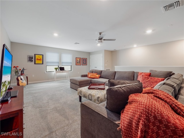 carpeted living room with ceiling fan