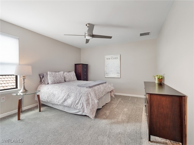 bedroom featuring light carpet and ceiling fan