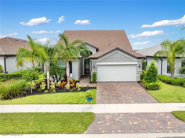 view of front of house featuring a garage and a front lawn