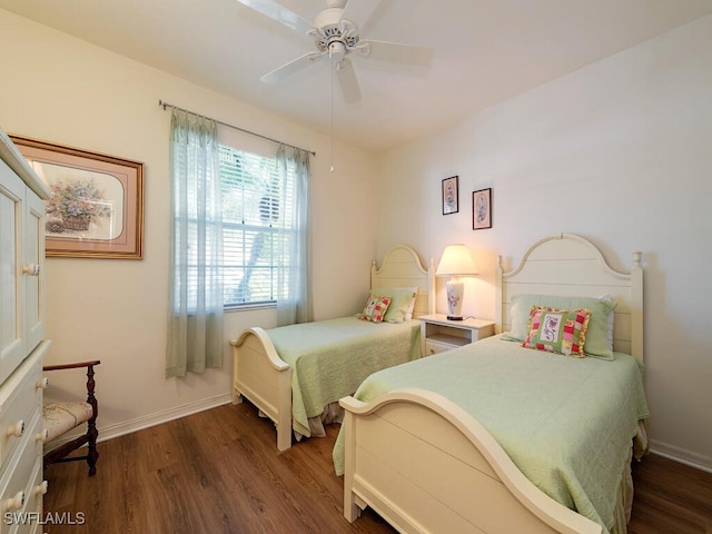 bedroom with ceiling fan and dark hardwood / wood-style floors