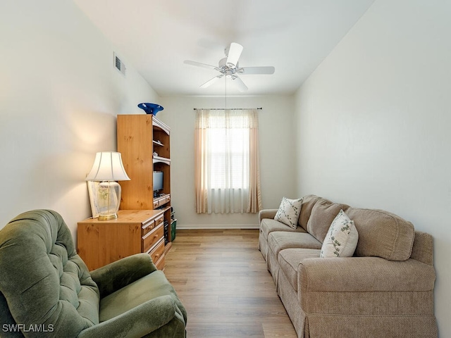 living room featuring light hardwood / wood-style floors and ceiling fan