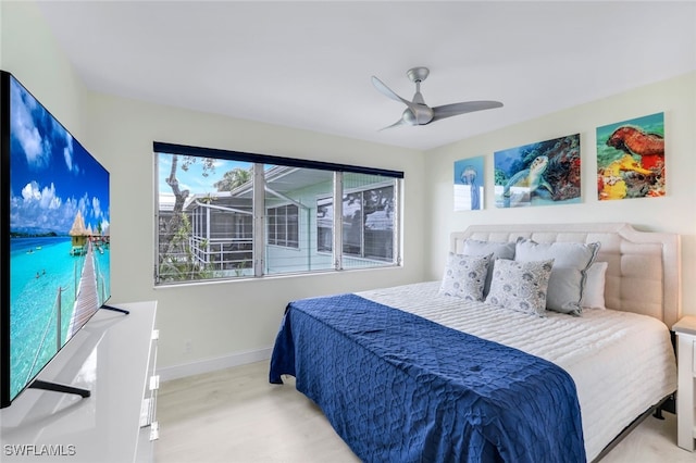 bedroom with ceiling fan and light hardwood / wood-style flooring