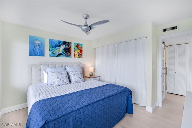 bedroom with ceiling fan and light hardwood / wood-style flooring