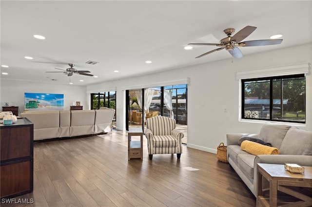 living room featuring ceiling fan, recessed lighting, wood finished floors, and baseboards