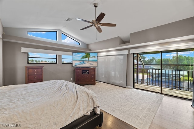 bedroom featuring access to exterior, vaulted ceiling, wood finished floors, and ceiling fan