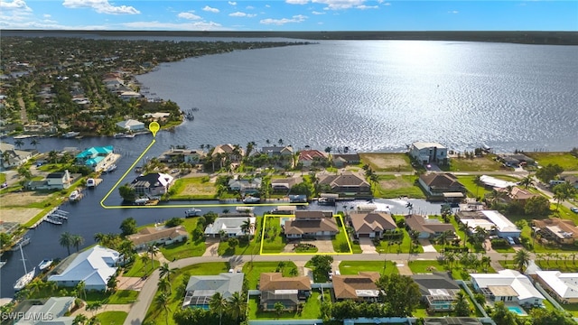 aerial overview of property's location featuring nearby suburban area and a nearby body of water