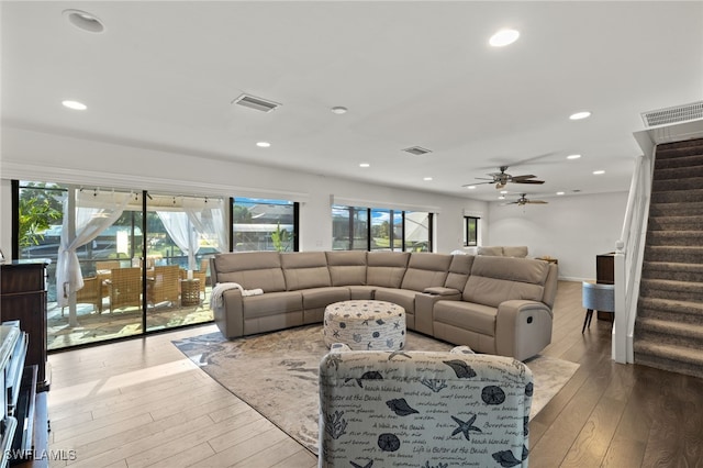 living room with stairs, hardwood / wood-style floors, recessed lighting, and ceiling fan