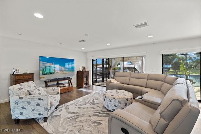 living room with plenty of natural light, wood finished floors, recessed lighting, and baseboards