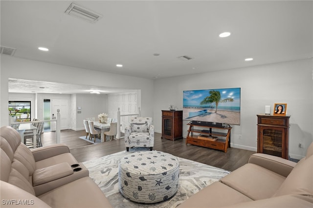 living area featuring baseboards, wood finished floors, and recessed lighting