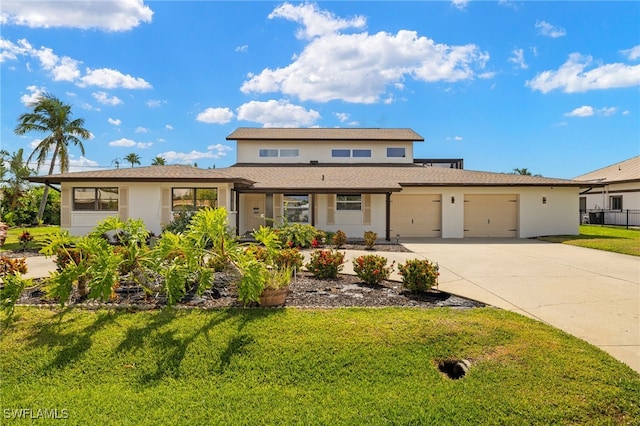 traditional-style home with a garage, driveway, a front lawn, and stucco siding