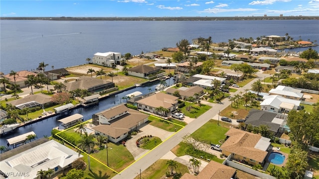 aerial perspective of suburban area featuring property boundaries highlighted and a nearby body of water