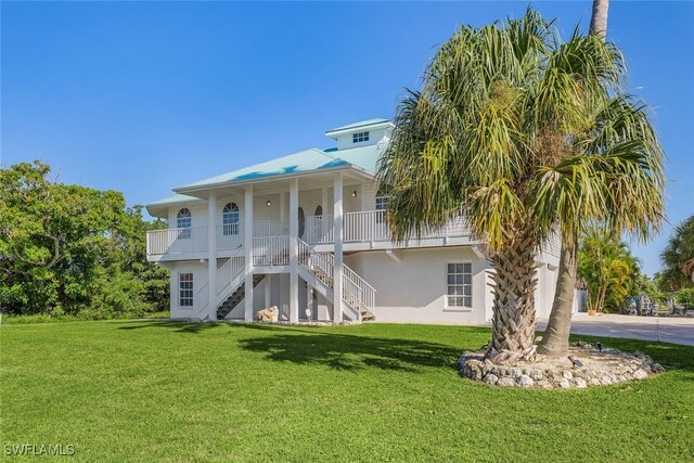 back of house with a lawn