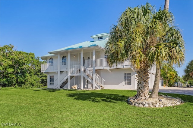 rear view of house with a yard and covered porch