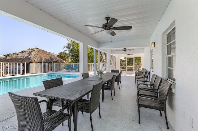 view of patio / terrace with ceiling fan and a fenced in pool