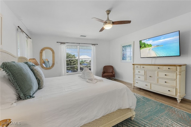 bedroom featuring hardwood / wood-style flooring and ceiling fan