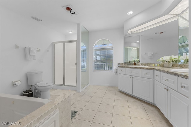 bathroom with tile patterned flooring, vanity, walk in shower, and toilet