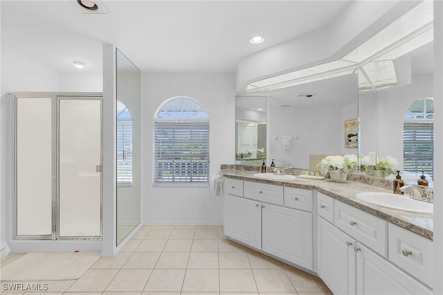 bathroom featuring vanity, tile patterned floors, and a shower with shower door