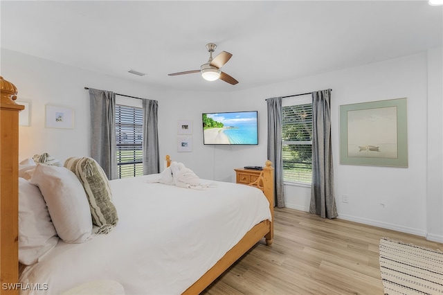 bedroom with light hardwood / wood-style floors and ceiling fan