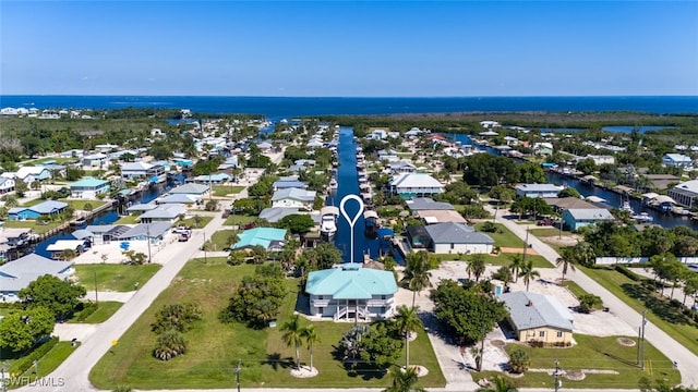 aerial view of residential area featuring a large body of water