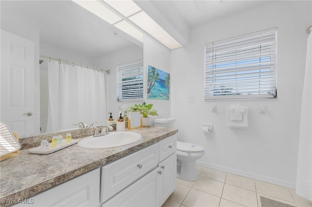 bathroom with vanity, tile patterned floors, and toilet