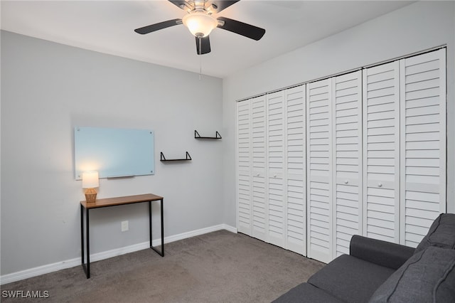 sitting room featuring carpet and ceiling fan