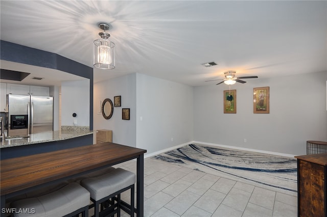 dining room with ceiling fan and sink