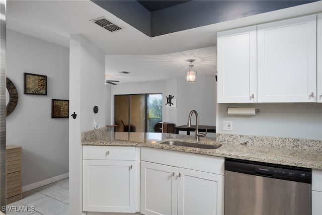 kitchen with sink, light tile patterned floors, stainless steel dishwasher, kitchen peninsula, and white cabinets