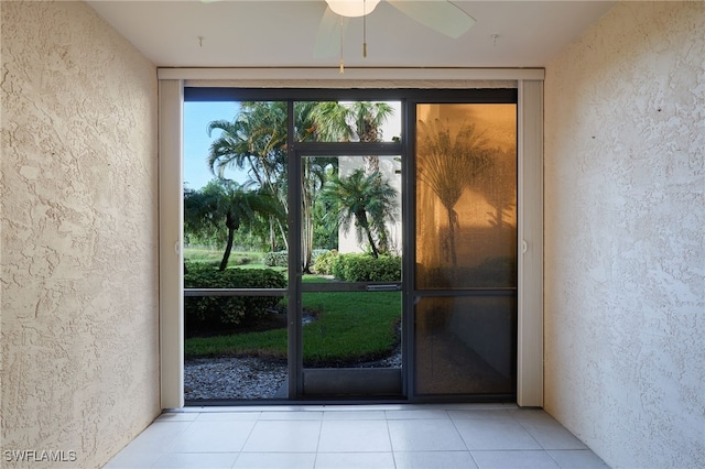 entryway featuring floor to ceiling windows, light tile patterned floors, and ceiling fan