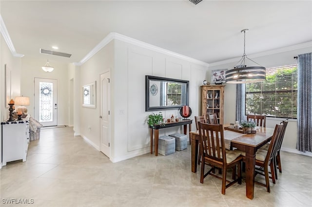 dining room with a healthy amount of sunlight, crown molding, and a chandelier