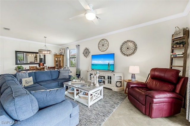 tiled living room featuring crown molding and ceiling fan with notable chandelier