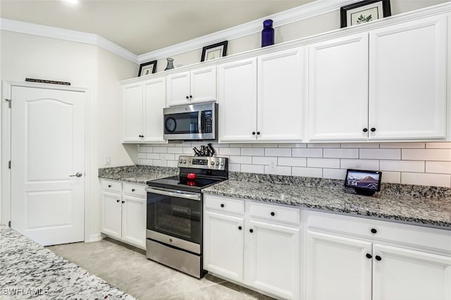 kitchen with backsplash, light stone counters, white cabinets, and appliances with stainless steel finishes