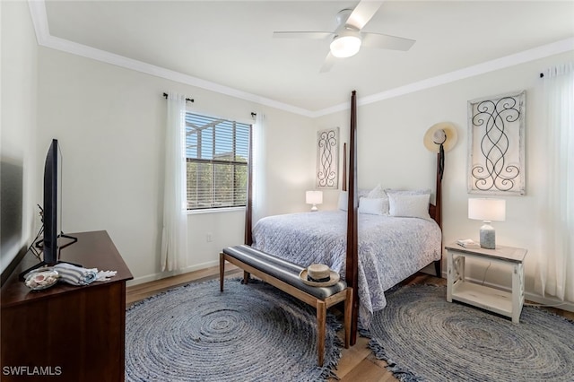 bedroom featuring ceiling fan, hardwood / wood-style floors, and ornamental molding