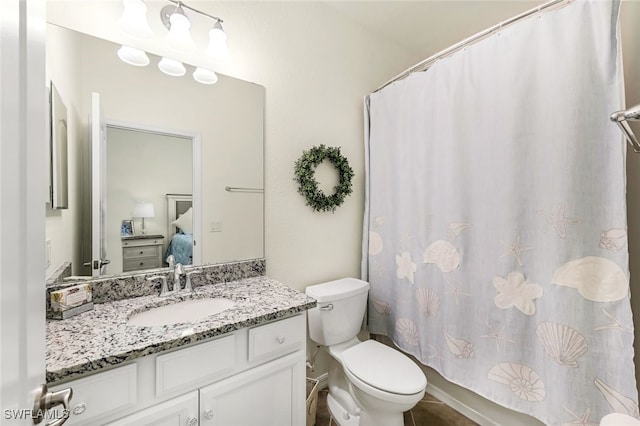 bathroom featuring vanity and toilet