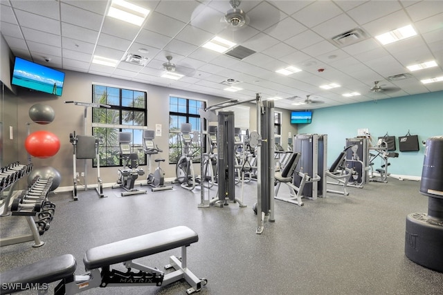 workout area with ceiling fan and a drop ceiling