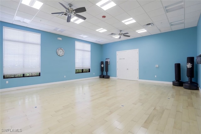 interior space featuring a drop ceiling and light wood-type flooring