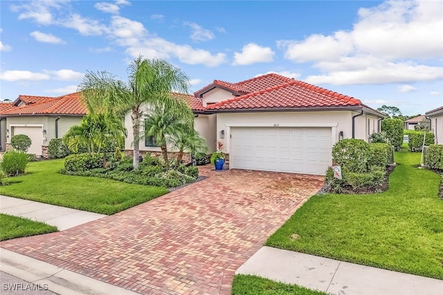 mediterranean / spanish-style house with a garage and a front yard