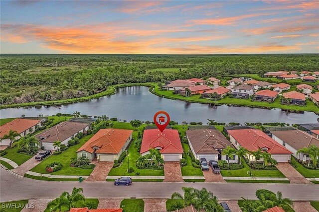 aerial view at dusk with a water view