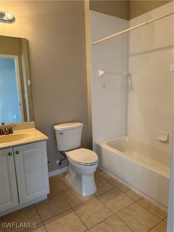 full bathroom featuring vanity, toilet, tiled shower / bath combo, and tile patterned floors