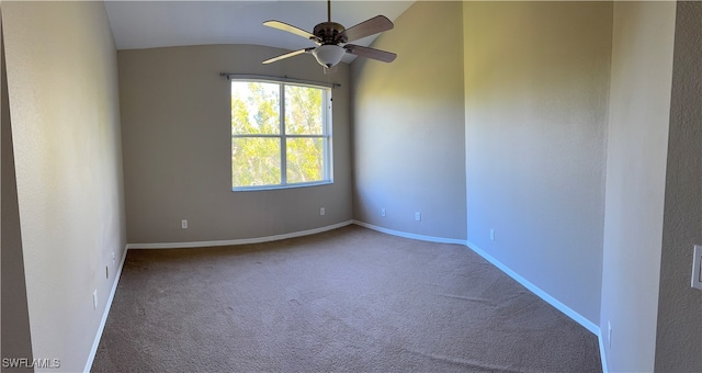 empty room featuring lofted ceiling, carpet floors, and ceiling fan