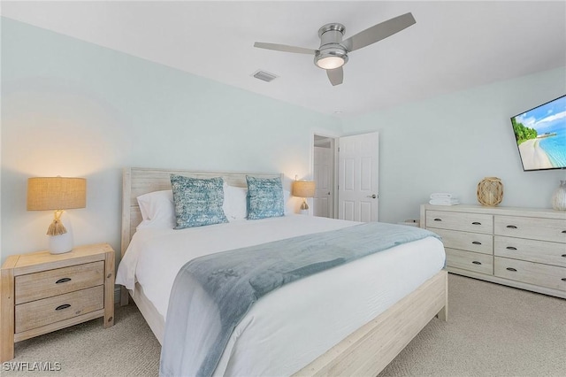 bedroom featuring light colored carpet and ceiling fan