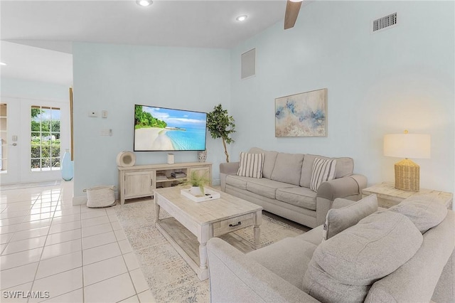 living room featuring ceiling fan, a high ceiling, and light tile patterned flooring