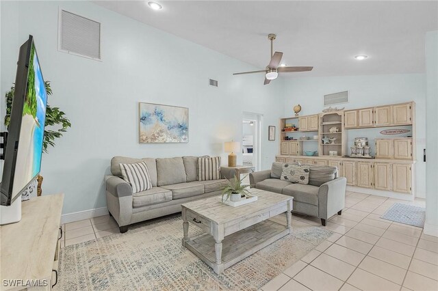 tiled living room with high vaulted ceiling and ceiling fan