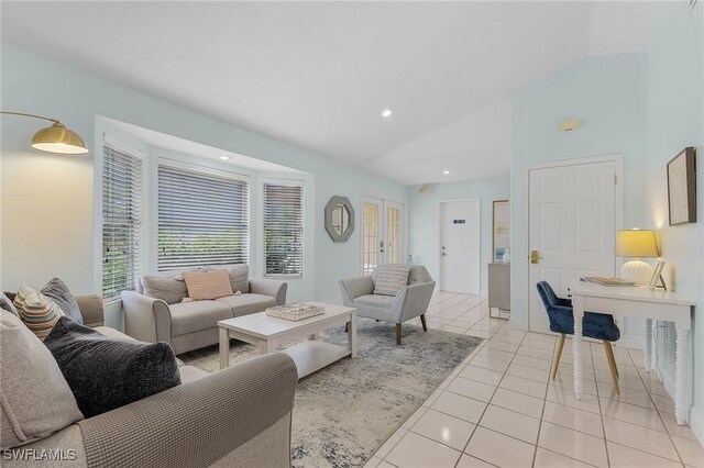 living room with light tile patterned floors and vaulted ceiling