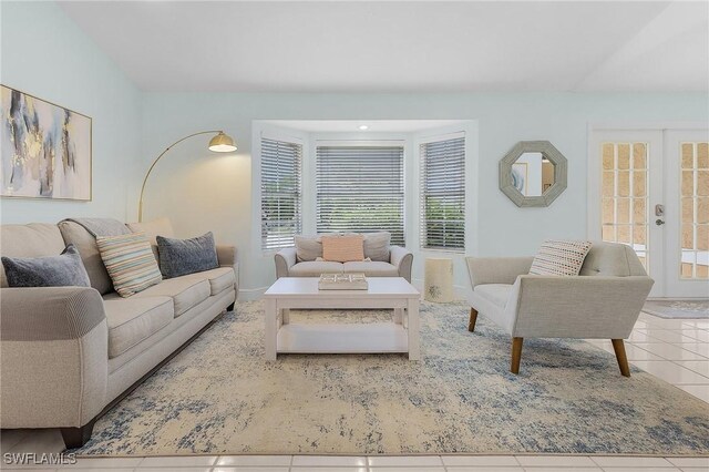 living room featuring french doors and light tile patterned floors