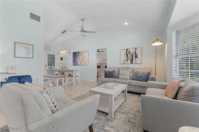 tiled living room featuring high vaulted ceiling and ceiling fan