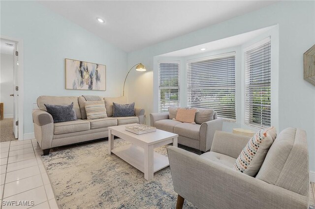 living room with lofted ceiling and light tile patterned floors