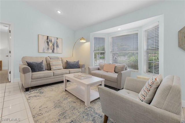 living room with vaulted ceiling and light tile patterned floors