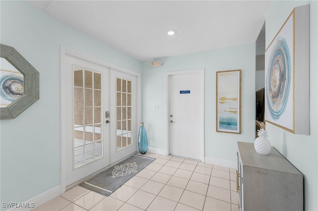 entrance foyer with light tile patterned floors and french doors